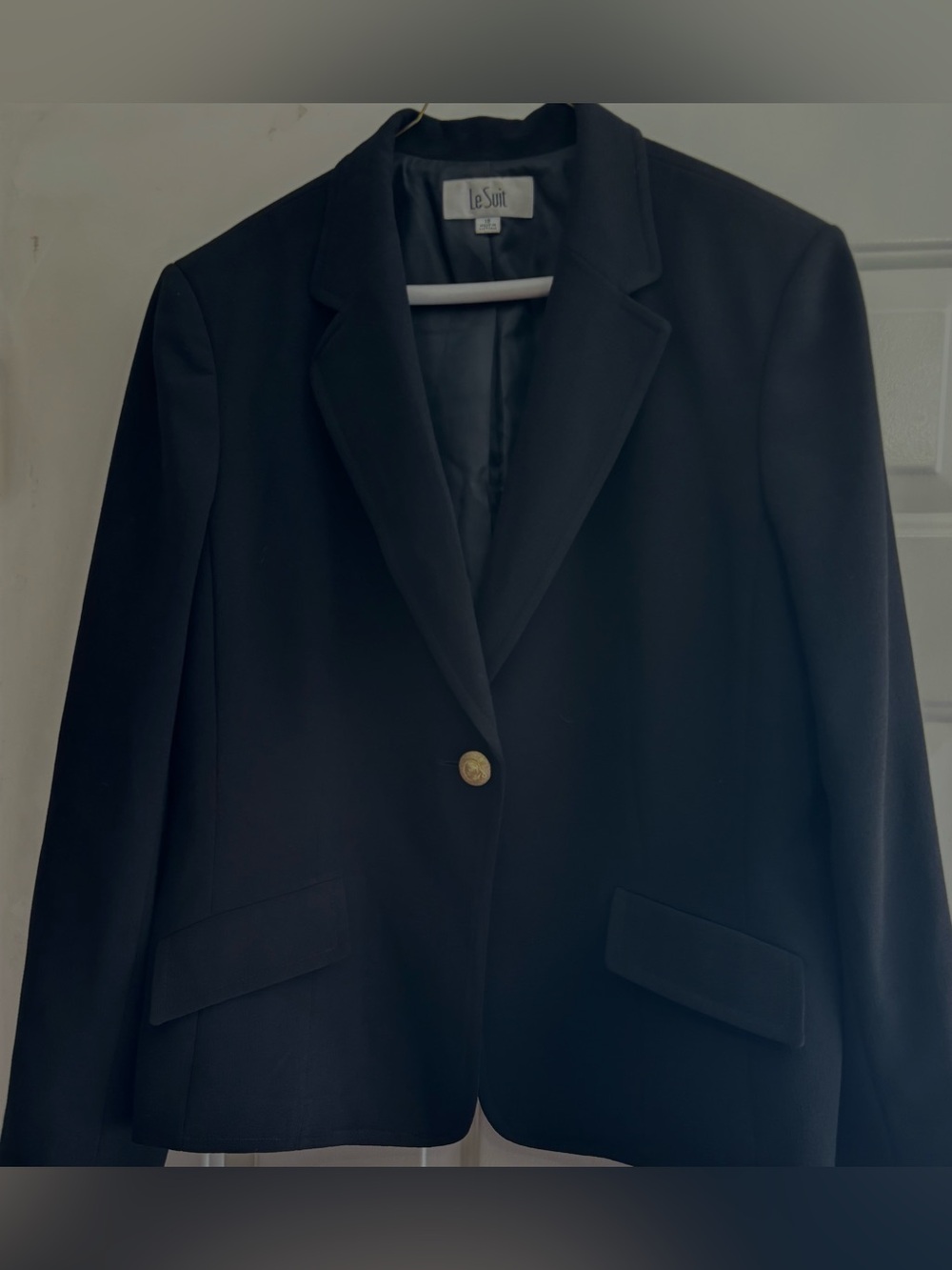 Black single-breasted blazer with gold button and pockets